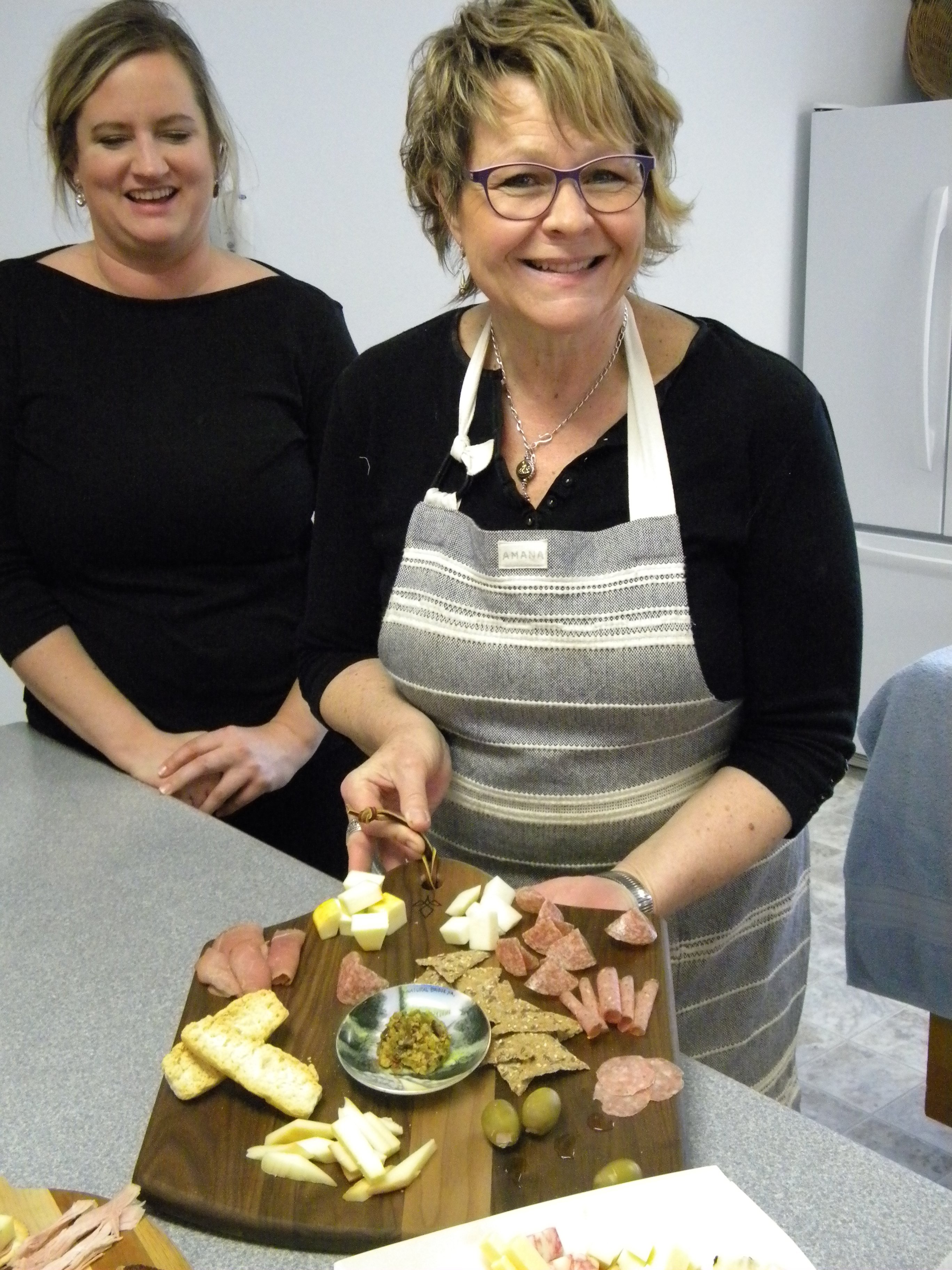 Carol Zuber with charcuterie board at "Take A Bite" festival activity